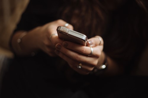 A close up of hands using a mobile phone