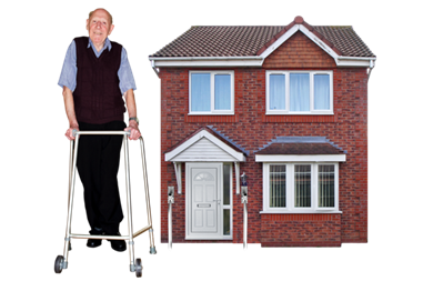 A man using a walking frame in front of a house. 