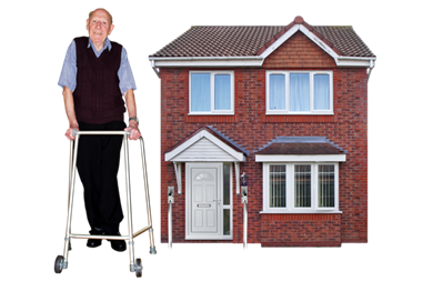 A man using a walking frame in front of a house.