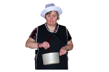 A woman wearing an apron and cooks hat stirring a pan. 