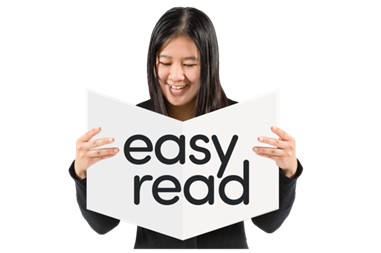 A woman holding an easy read booklet.